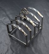 A George V silver toast rack, of traditional form having an angular handle, marks for Birmingham