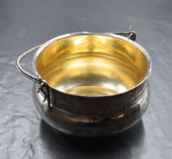 A 20th century silver sugar bowl, having a flared rim with decorative scroll border and 'Lolita'