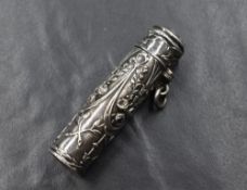 A French 19th century silver scent bottle, of cylindrical form having embossed floral and swag
