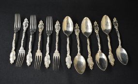 A set of six German white metal 800. Grade spoons, having ornate scroll handles with 'ES' monogram