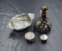 A silver mounted glass scent bottle, of bulbous form having pierced silver scroll decoration, marked