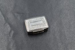 An early William IV silver vinaigrette, of hinged rectangular form having scroll engraving with a