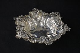 A 20th century silver bowl, of hexagonal form having daisies moulded in relief to the rim, with a