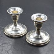 A pair of 20th century silver candle sticks, of squat traditional form, having gadrooned