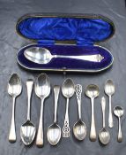 A cased Edwardian silver spoon, having scroll decoration to the terminal, marks for London 1906,