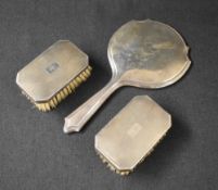 A pair of Elizabeth II silver mounted clothes brushes, having engine turned decoration and