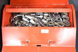 A red toolbox containing a socket set etc.