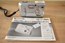 A Fujifilm Finepix A303 point and shoot digital camera, with users manual and a Lowepro carry case.