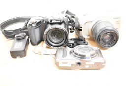 Three digital cameras. A Minolta Vectis S100 with Minolta 28-56mm 1:4-5,6 lens, a Nikon Coolpix