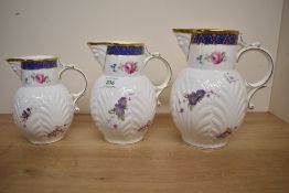 A set of three Coalport Caughley Mask-Headed Jugs in ascending sizes 14, 17 and 19cm in height.