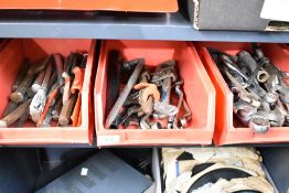 Three stacking storage boxes containing a selection of assorted tools including spanners and chisels