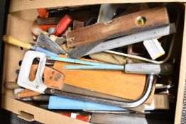 A collection of assorted woodworking tools including saws, hacksaws, and planes etc.