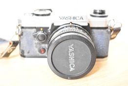 A Yashika X-D Quartz 35mm film camera; sold with Tamroon Adaptall-2 Custom Mount for Yashica/Contax,