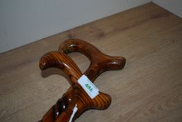 Two wooden walking sticks one with a decorative twist to the shaft