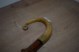 A blackthorn walking cane with carved shepherds crook handle measuring 84cm long