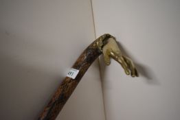 a walking stick measuring 87cm long the outside of the stick is snakeskin and the metial handle is