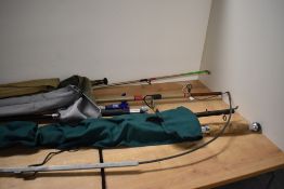 A selection of vintage fishing rods and rod restsand associated equipment including a split cane