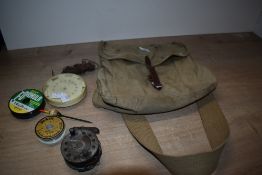 A small single buckle lightweight Hardy canvas and Leather fishing bag containing an old reel line