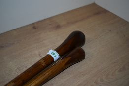 Two polished bulbus ended walking canes made from two woods probably ash shafts with mahogany