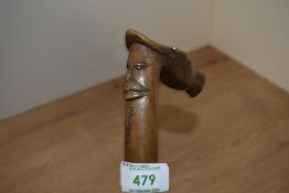 A late 19th early 20th century olive wood carved walking stick depicting a bearded man and a