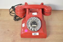 An early 20th-century GPO 332L red Bakelite telephone, 15cm in height, condition is consistent