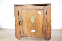 An unusual 19th-century Arts and Crafts oak smoking cabinet, of tapered form, having Edwardian-style