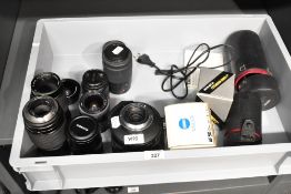 A collection of nine camera lenses. A Sigma Mirror-Telephoto 1:8 600mm, a Sirus Semi Fish-Eye 0.42X,