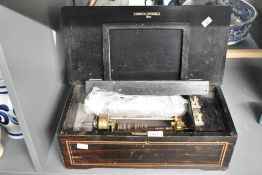 A late 19th to early 20th-century cylinder music box, rosewood with inlaid decorative elements and