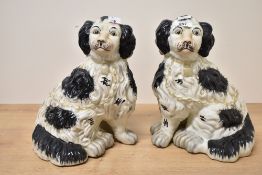 A pair of reproduction Victorian Staffordshire pottery-style mantel dogs, featuring hand painted