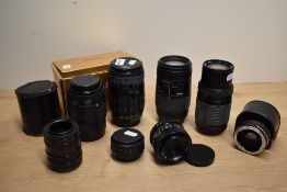 A collection of lenses. A boxed Sigma 70-30mm 1:4-5,6 DL Macro Super, a Sigma UC Zoom 70-200mm 1:4-