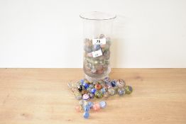 A quantity 19th and 20th-century assorted glass marbles in a glass conical flask, featuring