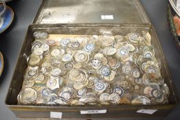 A tin full of vintage glass watch faces of varying sizes, to include a selection of French examples,