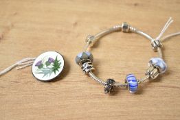 A Pandora snake chain bracelet, having eight charms including three blue glass charms and a Westie