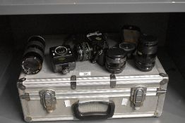 A Canon A-1 camera with Canon FD 50mm 1:1,8 lens, Canon FD 35-70mm 1:4 lens, a Mitakon 1:2,8 28mm