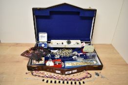 A wooden canteen repurposed as a jewellery box, containing an assortment of costume jewellery,