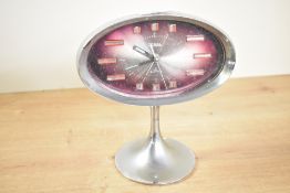 A vintage Japanese Coral 2 Jewels pedestal alarm clock, featuring a space-age oval design with a a