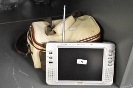 A vintage portable LCD television with antenna, accompanied by a canvas travel bag, 25cm x 17cm,
