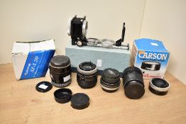 A collection a lenses. A Canon 100mm f2.8, a Carl Zeiss Jena 135mm f3.5, a Hanimex 28mm f2.8,