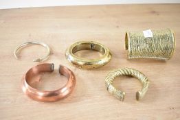 A quantity of 20th century African brass, metal and copper cuff bracelets, to include a twisted