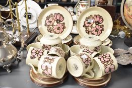 A Kiln Craft ironstone dinner service decorated with pink floral patterns, to include large dinner