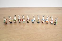 Vintage miniature wooden bunny orchestra figurines, featuring colourful hand-painted detailing, to