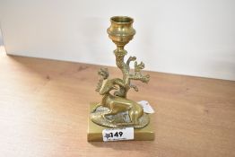 A Victorian cast brass deer candlestick, modelled as a kneeling doe before a tree, the trunk