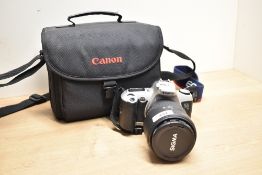 A Canon EOS500 35mm camera with Sigma Aspherical Hyperzoom 28-300mm 1:3,5-8,3 lens in soft camera