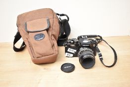 A Nikon FE2 camera with Nikon Micro Nikkor1:2,8 55mm lens in soft camera bag