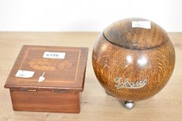 An early 20th-century Art Deco circular oak tobacco caddy, featuring a hinged lid, scrolled metal