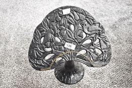 A 20th-century cast metal tabletop lectern in the style of 'Partridge in a Pear Tree,' unmarked,