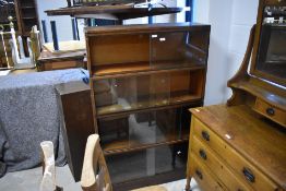 A 1940's oak four tier 'Angus' sectional stacking bookcase, with sliding glass doors, 35cm x 87cm