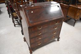 A good quality reproduction figured mahogany bureau, of traditional fall-front design with an