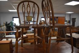 A pair of 19th century elm seated Windsor dining chairs, the hooped back with three shaped and