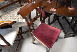 A group of four Victorian mahogany dining chairs, each with concave tablet top rail and carved mid